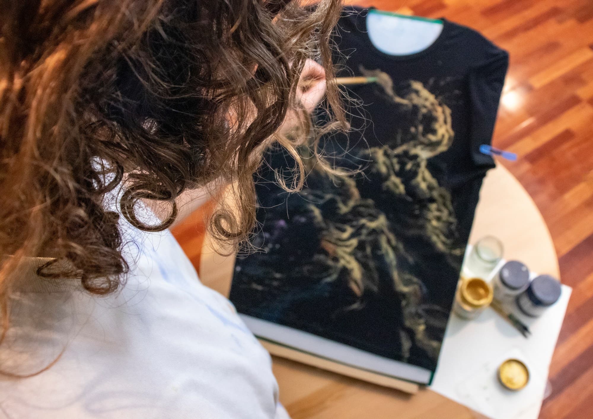 View over Sebastian’s shoulder as he paints a Galaxy shirt.
