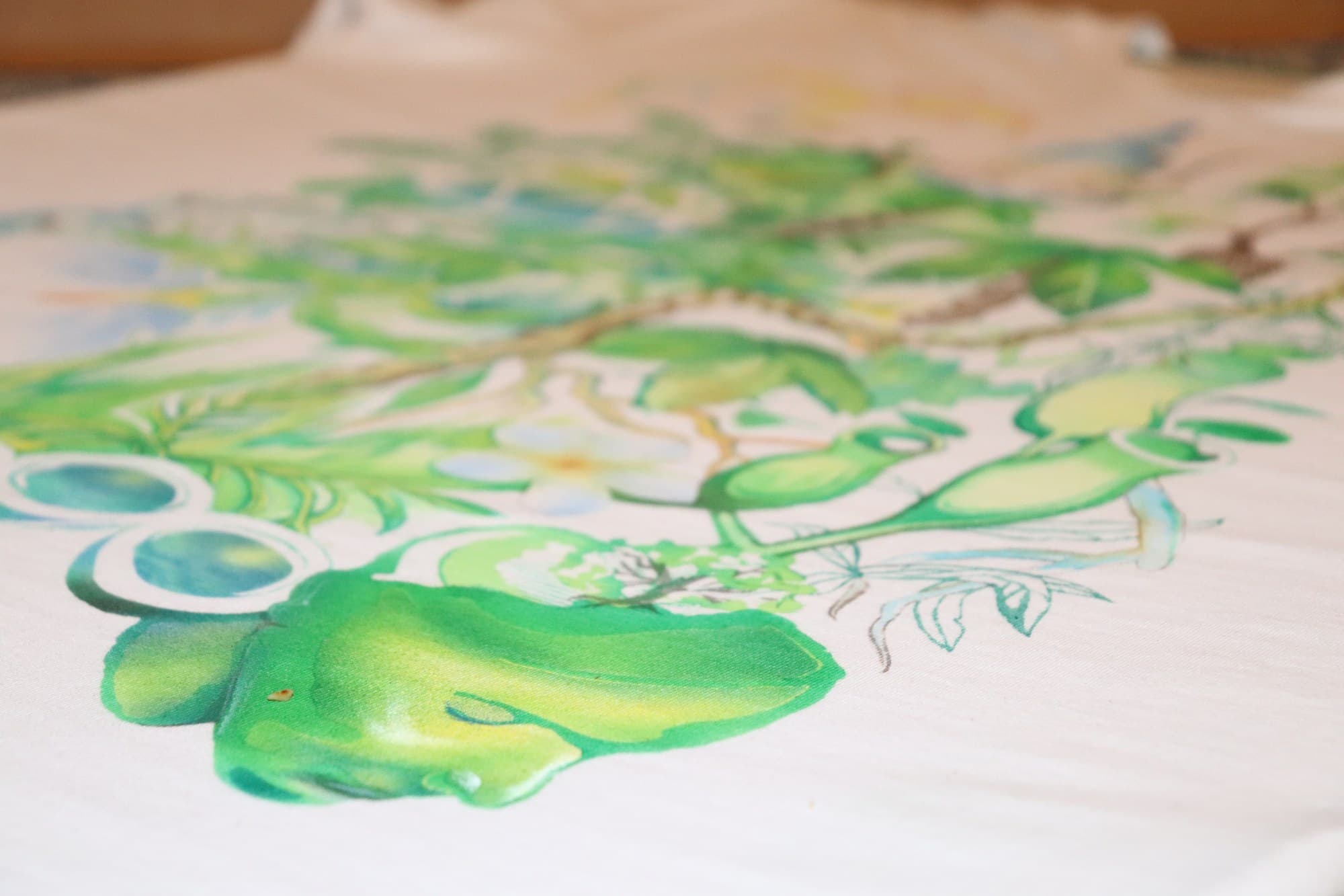 Low angle across the green foliage and colourful forms of a Jungle painting.